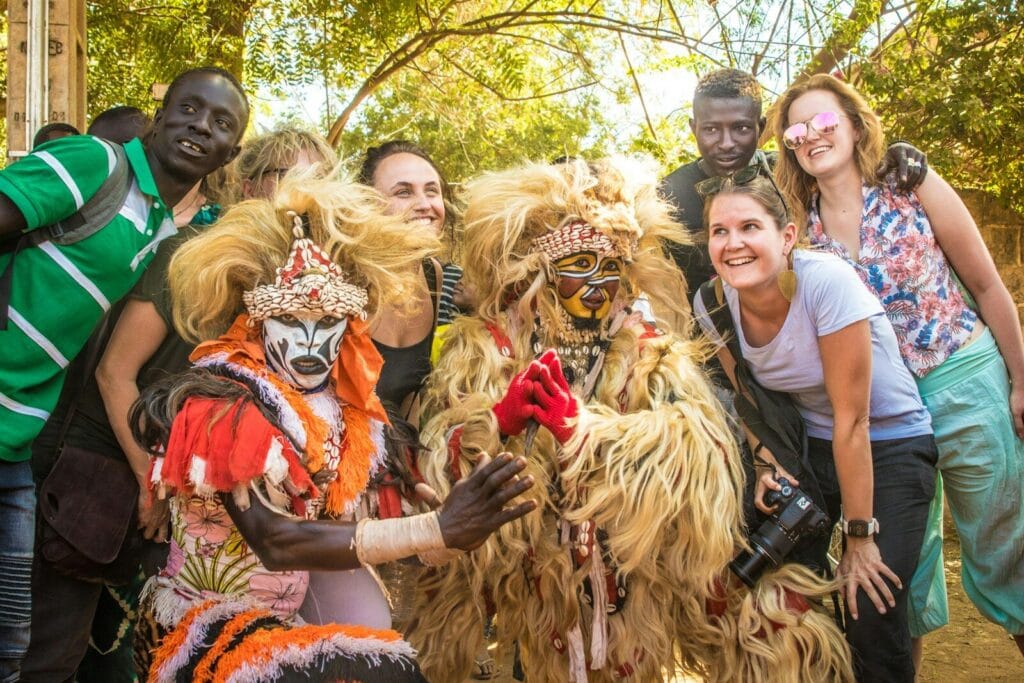 Group poses with a masked performer.